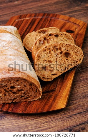 Sliced loaf of italian bread on a cutting board