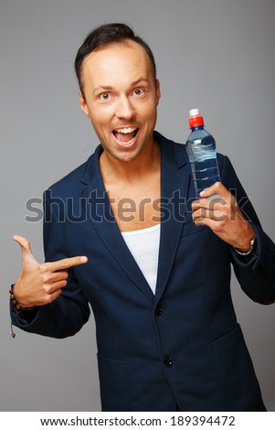 A man wearing a jacket with a plastic bottle