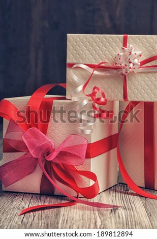 White boxes with red and pink ribbons