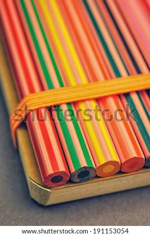 Coloring pencils fixed to a notebook with a rubber band