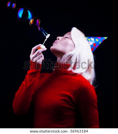 Portrait of attractive woman with pale face blowing bubbles