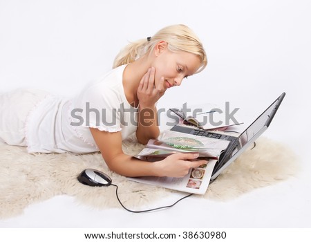 Portrait of attractive pensive girl resting and reading magazine