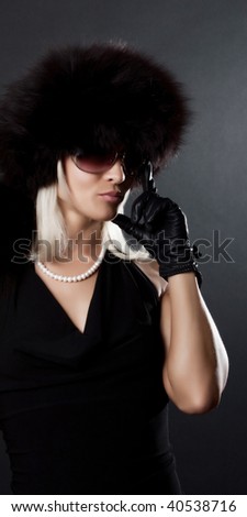 Portrait of sexy elegant female wearing black dress and gloves