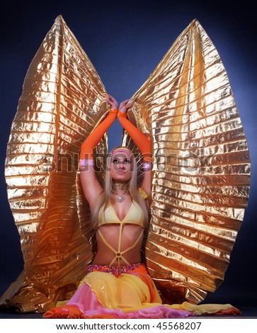 Adorable young woman with gold wings