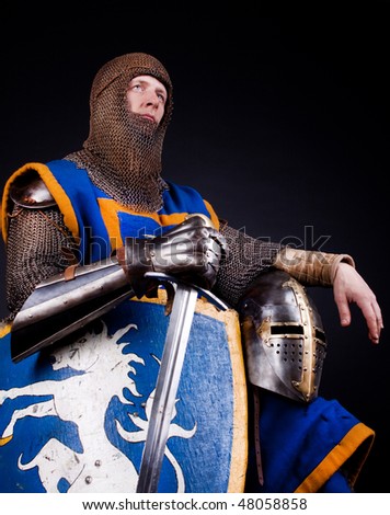 picture of knight with his sword, shield and helmet