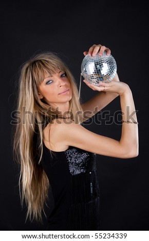Sexy woman is holding a sphere and posing