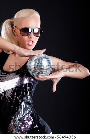 Young woman wearing sunglasses and holding a sphere