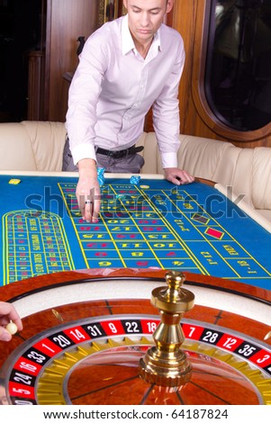 Image of handsome player near roulette