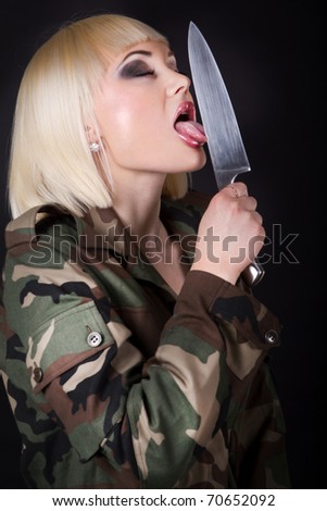 stock photo Shot of a beautiful girl lick a knife