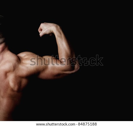 The athlete shows his powerfull arm and shoulder