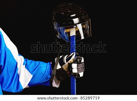 Picture of hockey helmet on hockey player stick