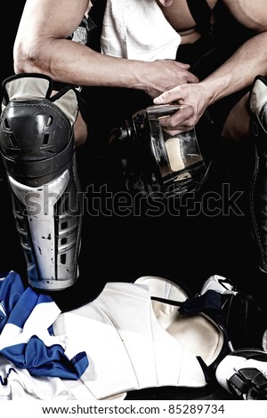 Picture of hockey player after game sitting in locker room