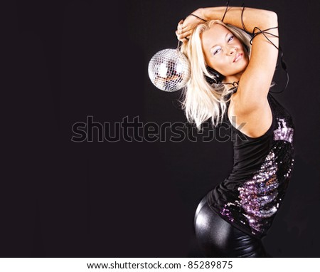 Hot blonde with disco ball dancing at party