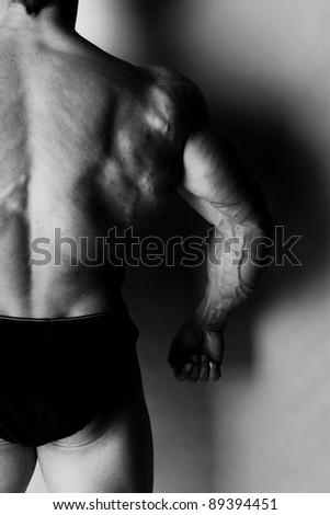 Black and white image of bodybuilders back