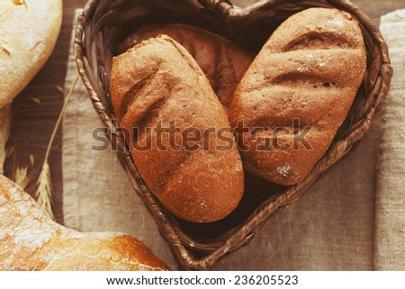 Bio bread in a wicker box on linen