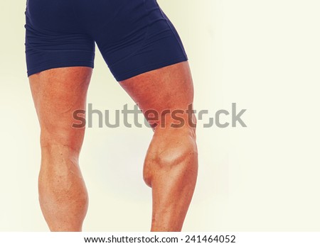 Close portrait of muscle man legs from behind