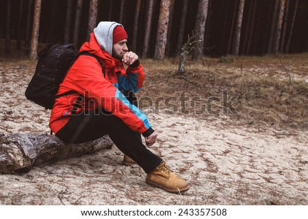 Hiker have short respite on his way in the forest