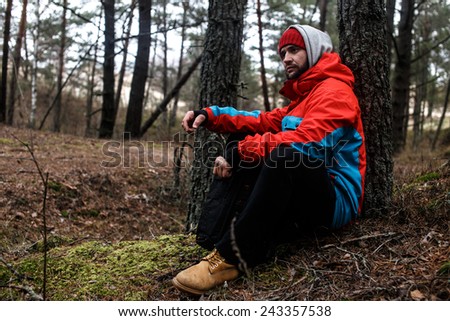 Hiker have short respite on his way in the forest