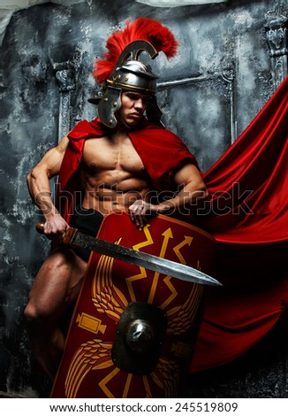 Roman warrior with muscular body holding sword and shield