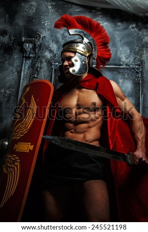 Roman muscular shaped warrioir with sword and shield in his hands