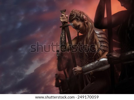Beautiful female warrior elf with sword over cloudy sky