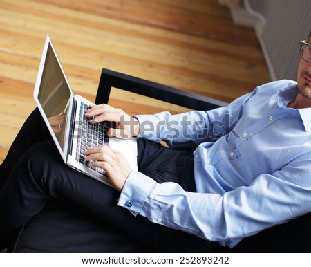Young business man working with laptop in office.
