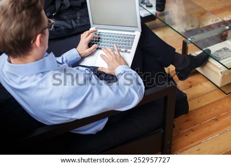 Young business man working with laptop in office.