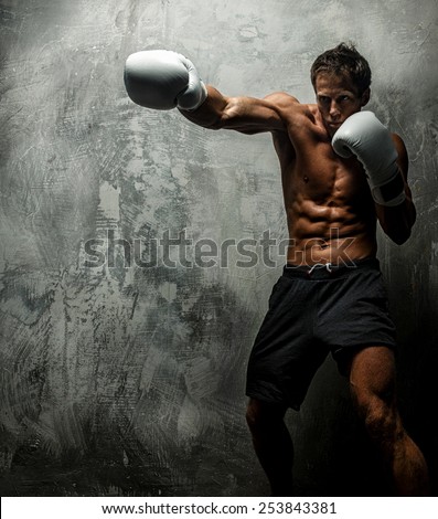 Awesome female with great antomy boxing. Grey background.