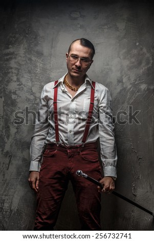 Male in white t shirt red pants and glasses.