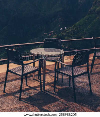 Calm recreation place with round table and chairs and beautiful view on mountains