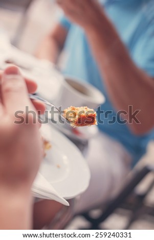 Two persons have lunch eating cake in calm environment