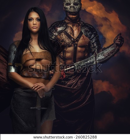 Male and female in ancient armor with swords
