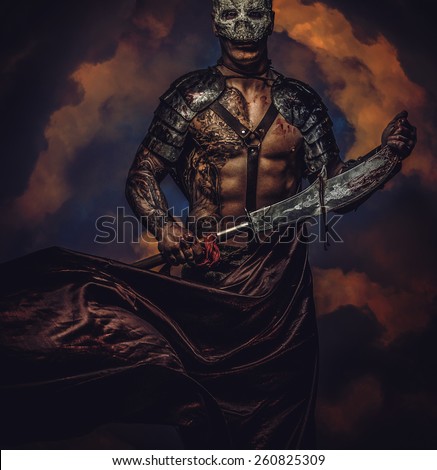 Brutal dangerous tattooed medievel fighter in skull mask in armor