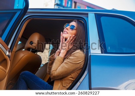 Awesome girl in sunglasses in a car back seats.