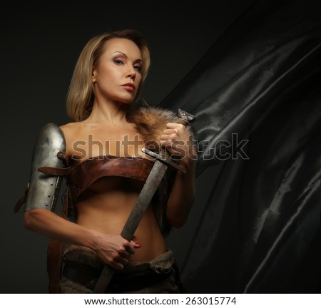 Awesome middle age woman with sword isolated on grey