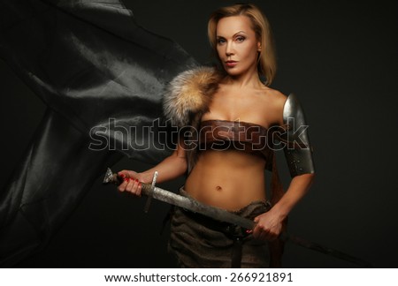 Middle age blond woman holding sword. Isolated on grey