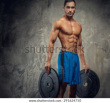 Shirtless muscular guy holding weights.