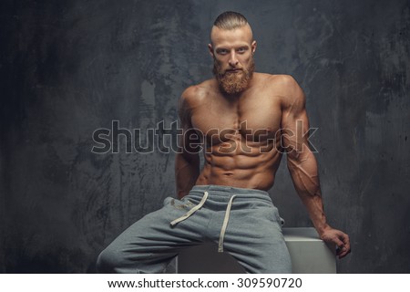 Shirtless muscular guy with beard showing his great body.