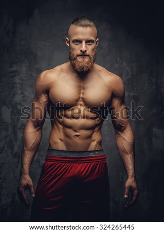 Portrait of strong muscular guy with beard.