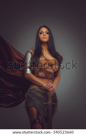 Portrait of Roman woman in armor holds sword.