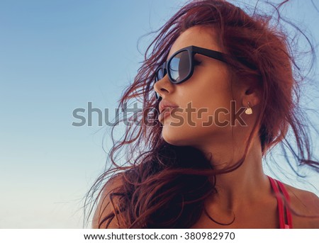 Close up portrait of brunette woman in a sunglasses.
