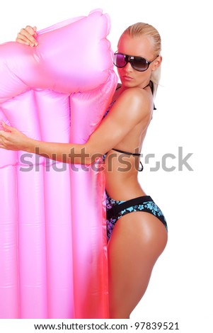 Image of woman in sunglasses standing with mattress