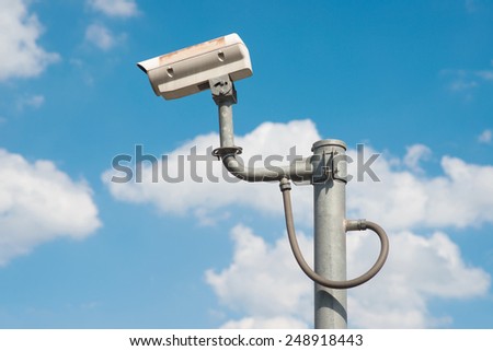 The traffic security CCTV camera operating on road detecting traffic.