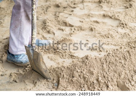 man digging in the ground with shovel and spade.