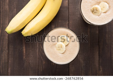 Top shot banana smoothie on wooden table