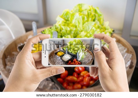 Taking photo of salad bar with vegetables in the restaurant