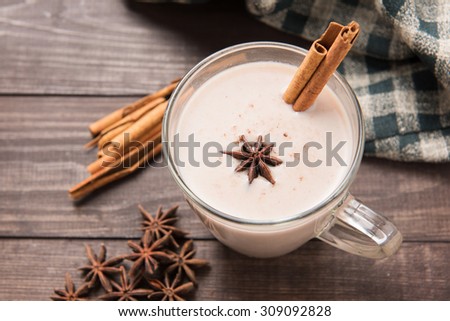 Masala chai with spices cinnamon , cardamom, ginger, clove and star anise on wooden background.