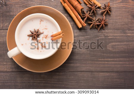 Masala chai with spices cinnamon , cardamom, ginger, clove and star anise on wooden background.