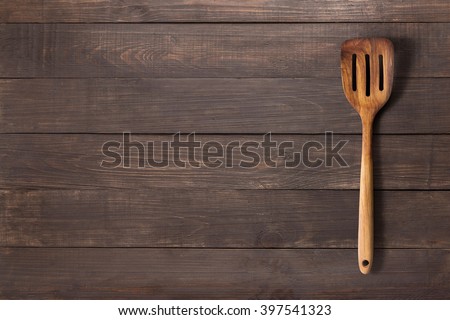 Spatula on the wooden background for you text.