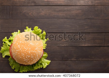 Top view bbq hamburger on the wooden background.